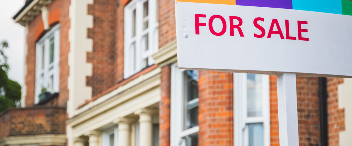 For Sale estate agent sign displayed outside a terraced house in Crouch End, London