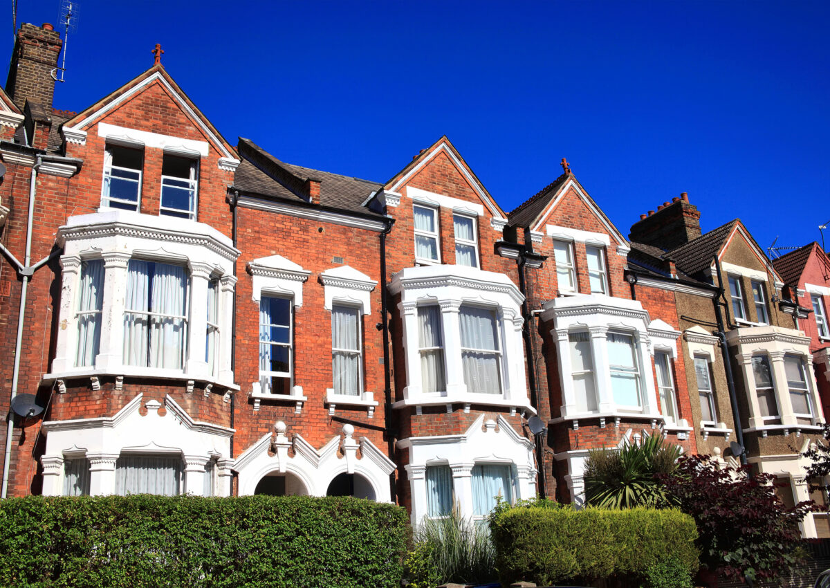 Old fashioned typical Victorian terraced town houses architecture in London, England, UK. These residential homes are often turned into apartment flats